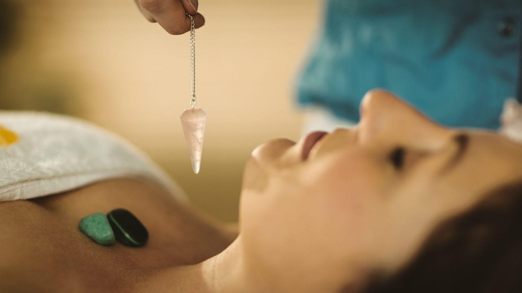 Young woman at crystal healing session in therapy room