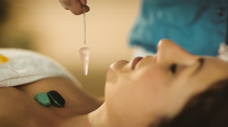 Young woman at crystal healing session in therapy room