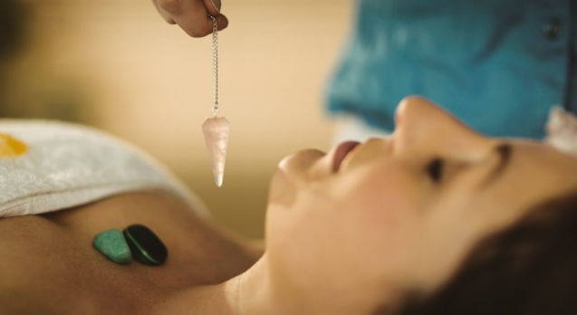 Young woman at crystal healing session in therapy room